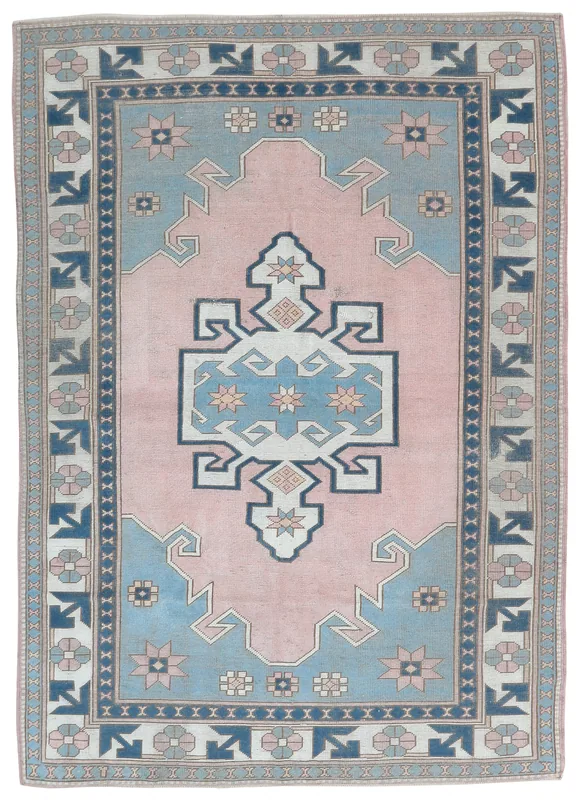 Full overhead view of the pink and blue geometric vintage Anatolian area rug