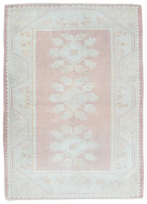 Full top view of the vintage pink and beige Anatolian rug on a white background