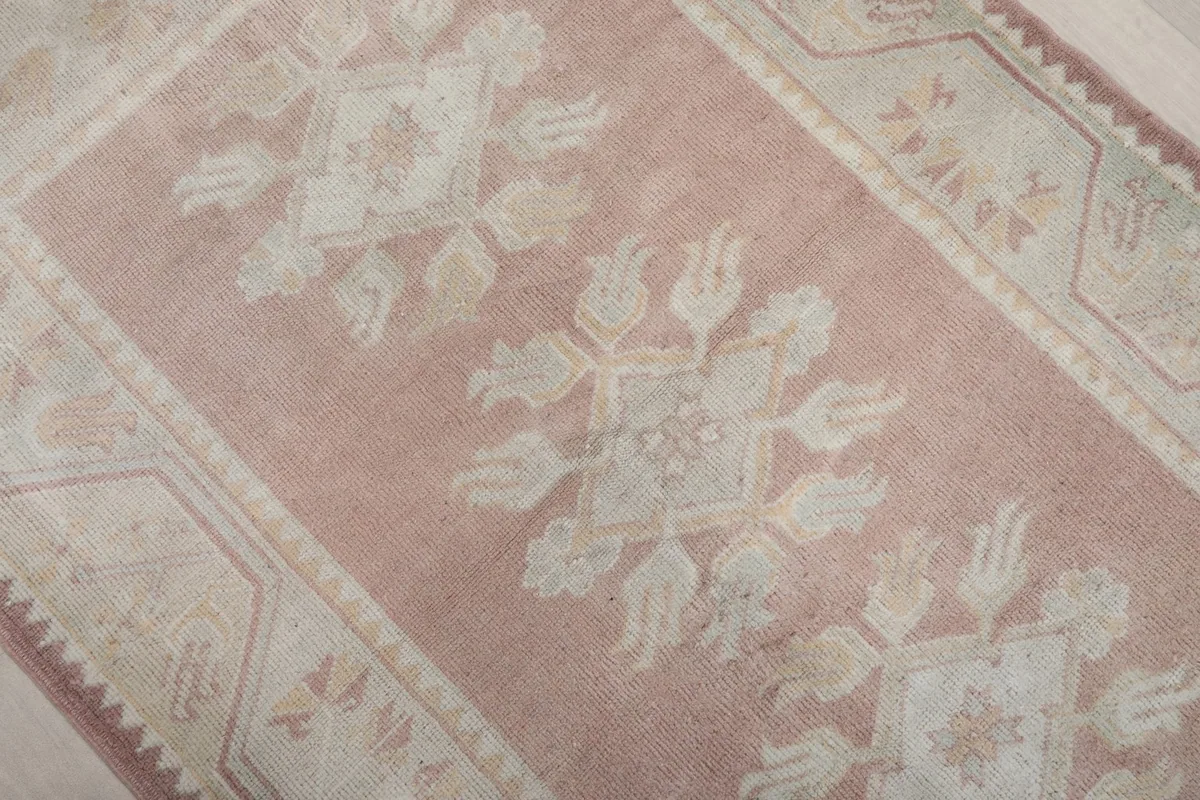 Overhead detail shot highlighting the floral motifs and texture of the rug's pile