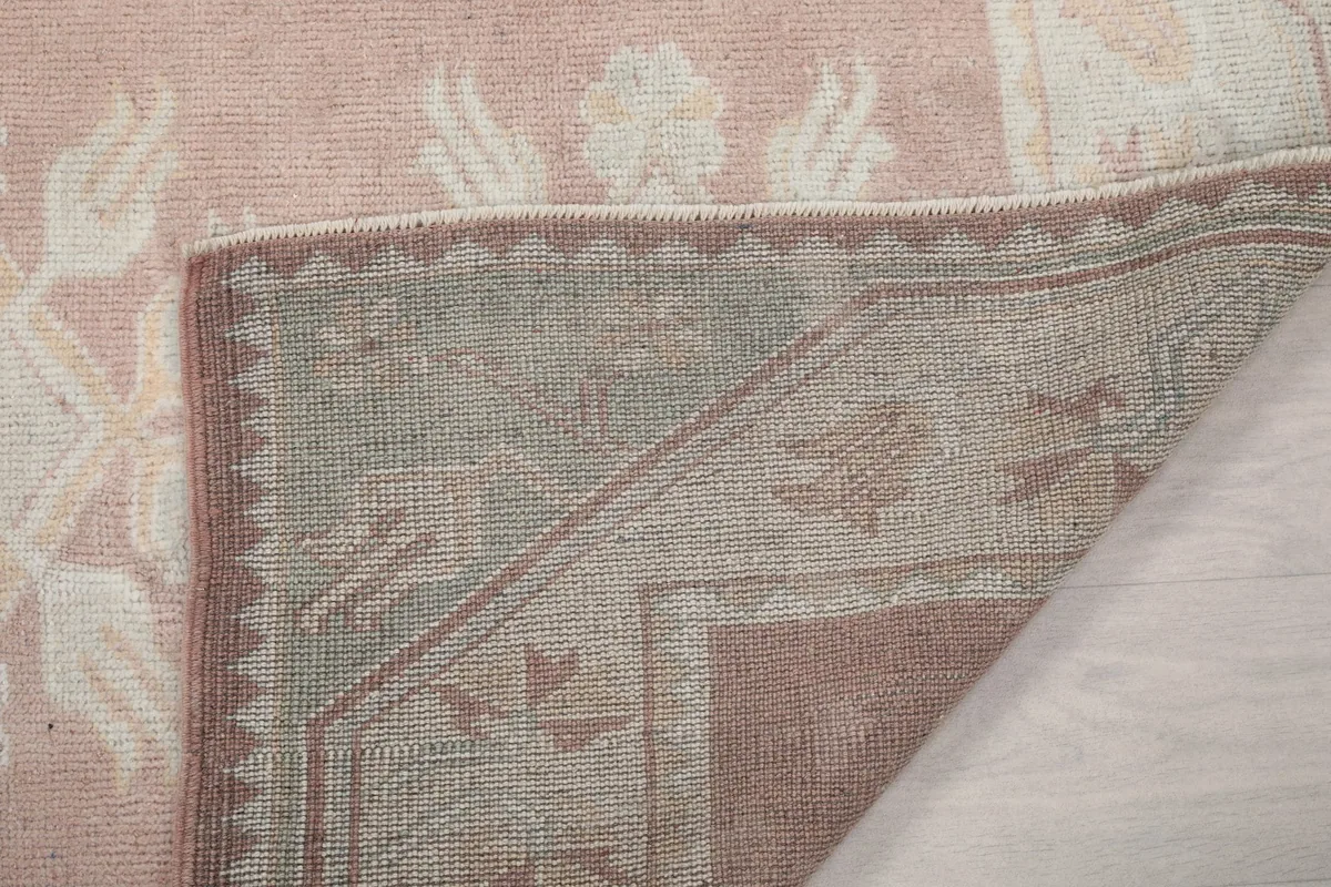 View of the back of the rug, showing the knotting structure and foundation