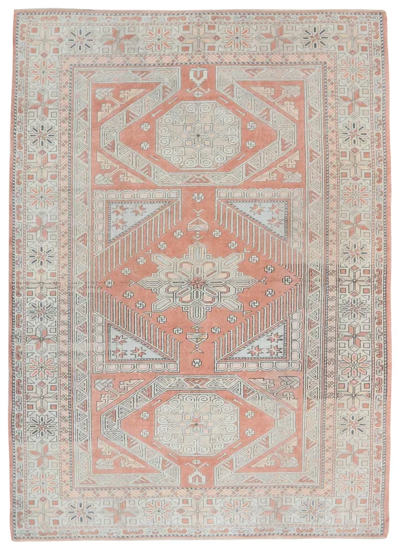 Full overhead view of the rust and beige geometric vintage Anatolian area rug on a white background