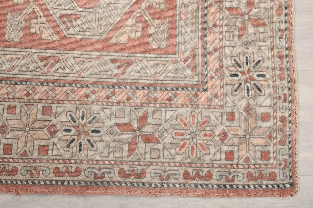 Another close-up of the rug's border and corner motifs, highlighting the hand-knotted craftsmanship