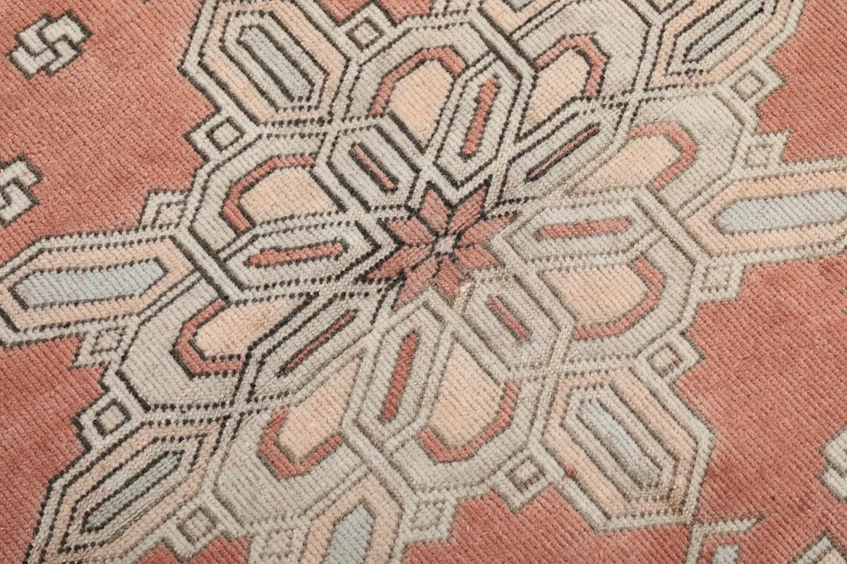 Extreme close-up of the wool pile, showing the texture and colors of the hand-knotted knots