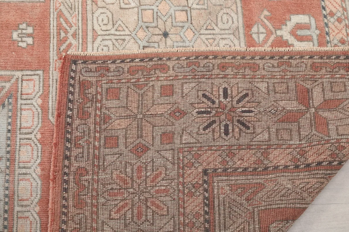 Close-up of the rug's backing and a corner, showing the tight knotting and foundation