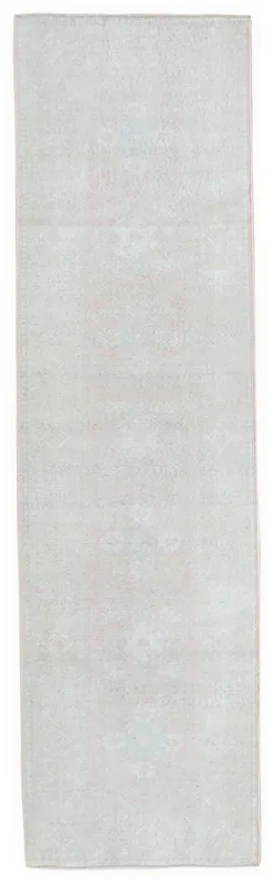 Full overhead view of the beige and rose vintage Anatolian runner rug on a white background