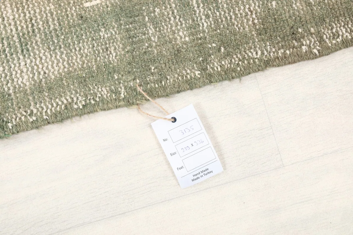Product tag attached to the rug, indicating its origin and material details
