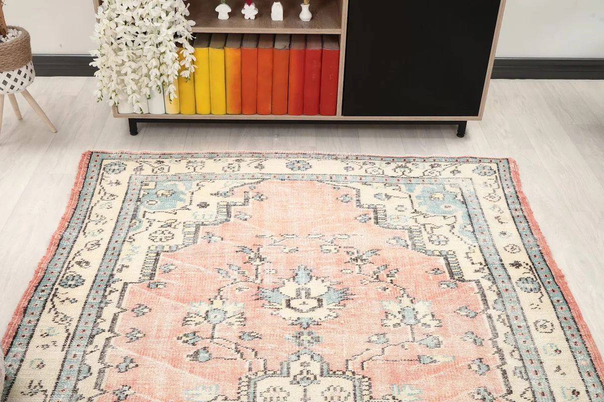 Overhead view of the vintage Anatolian rug in a room, highlighting its full design and colors.