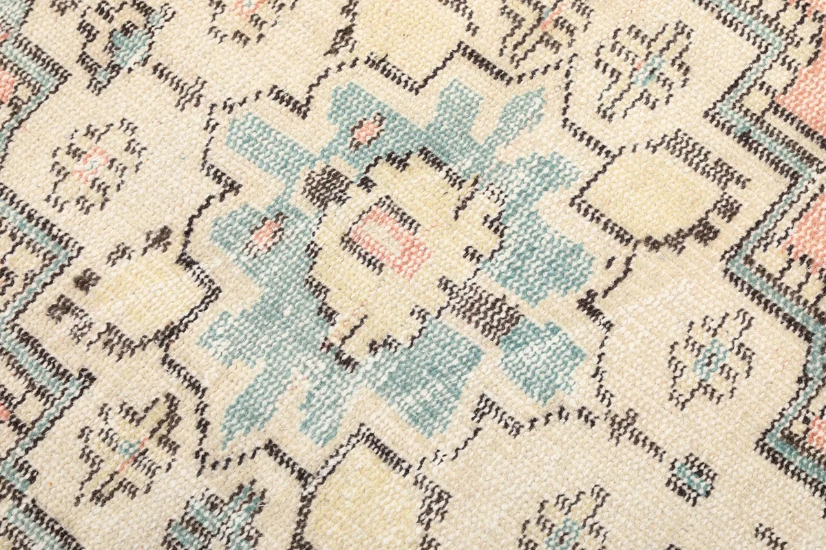Detailed view of the intricate geometric patterns and colors within the rug's design.