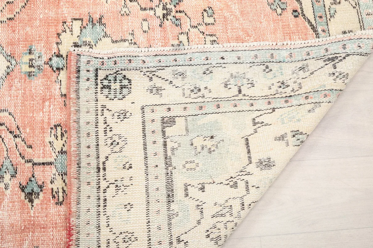 Close-up of the low wool pile and the construction of the hand-knotted vintage rug.