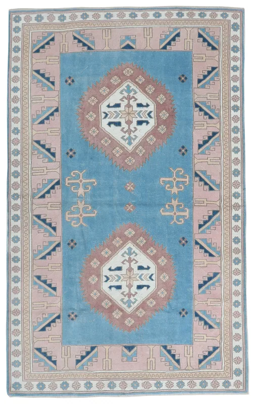 Full top view of the 6'2" x 8'8" vintage Anatolian rug with blue field and rose border