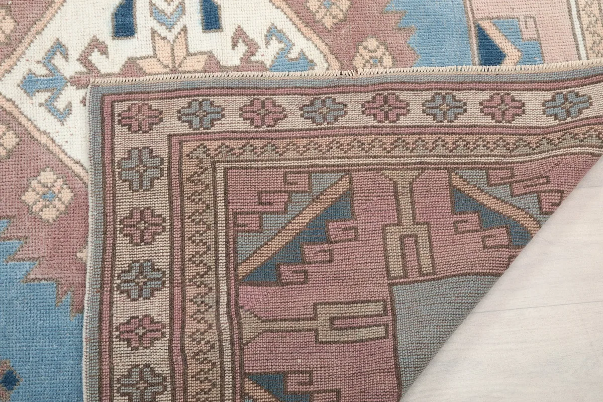 View of the back of the rug, showing the knots and construction of the wool pile