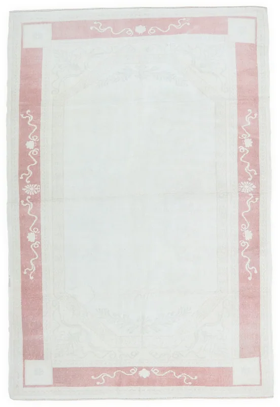 Full overhead view of the ivory and rose vintage Anatolian rug on a white background