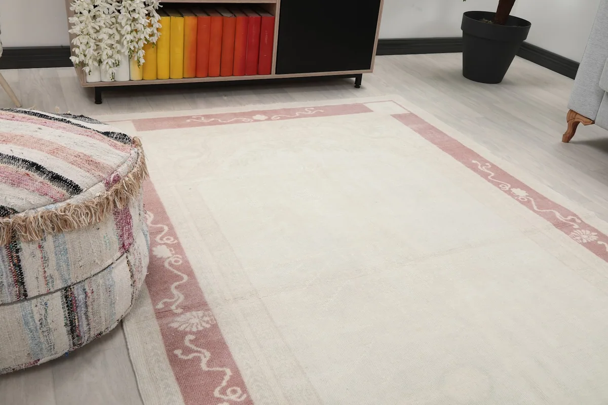 Close-up of the rug's corner and border pattern, showing subtle floral motifs