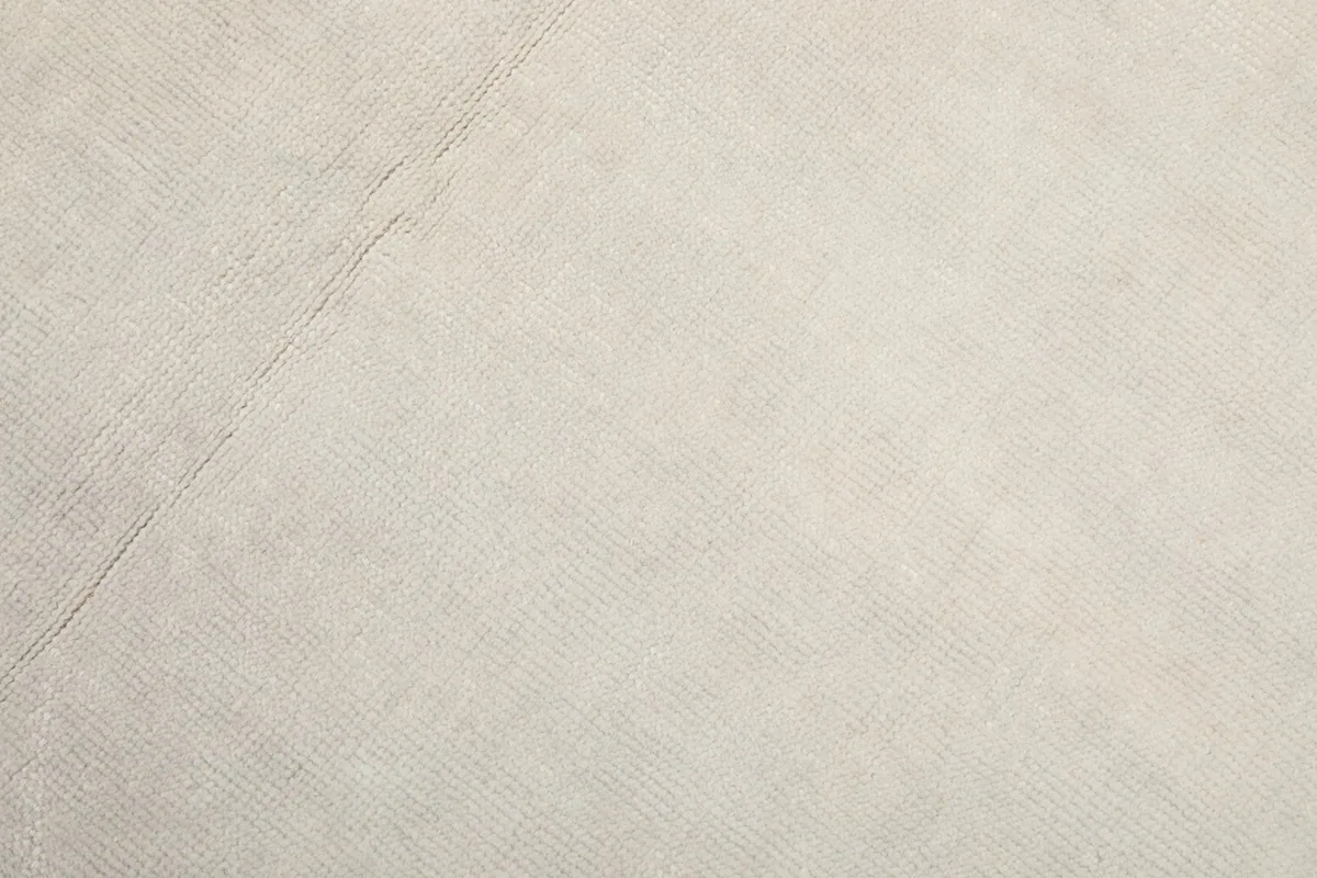 Close-up showing the low pile texture and weave of the vintage wool rug