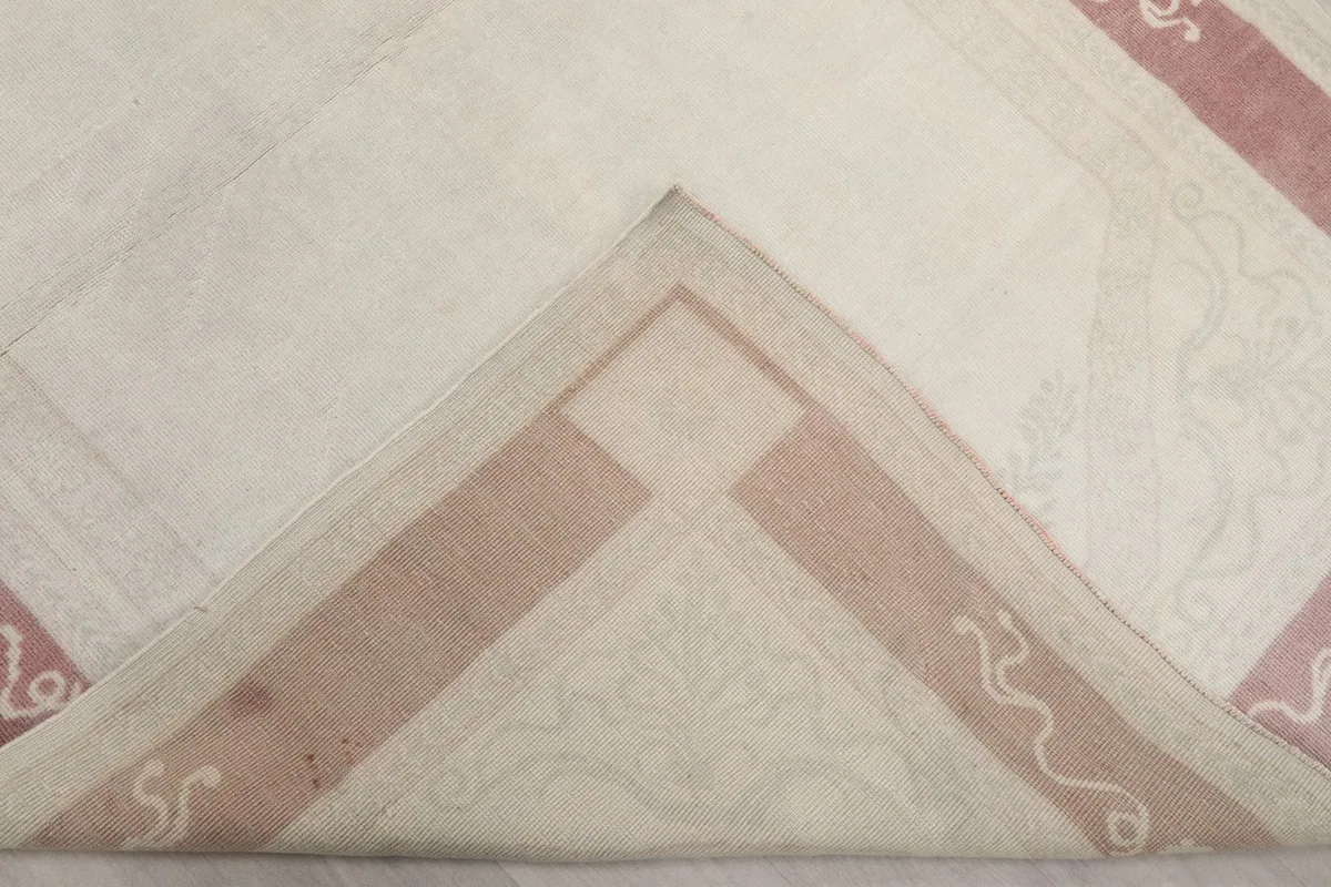 View of the back of the rug, showing the hand-knotted cotton foundation and wool pile