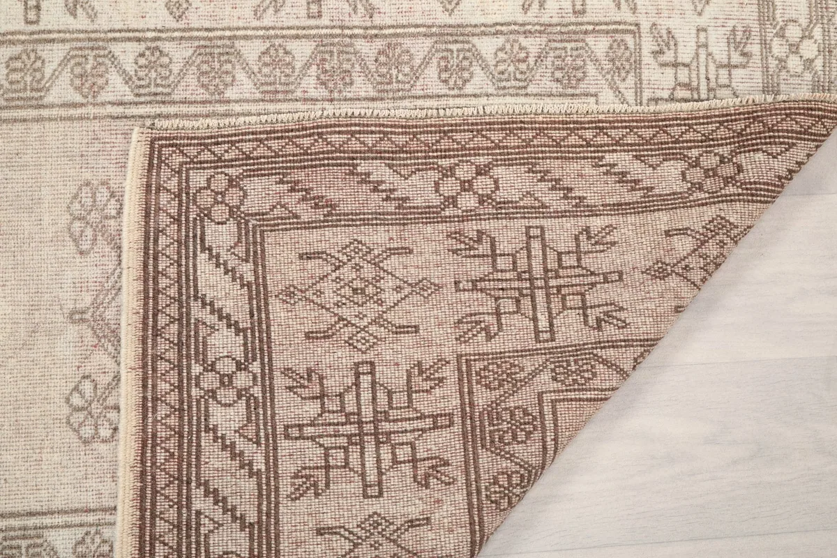Close-up of the rug's underside, revealing the cotton foundation and knotting.