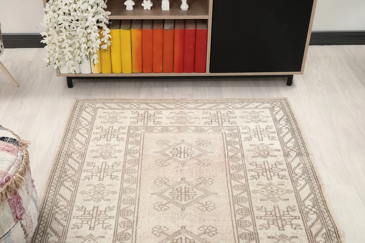 Overhead view of the rug in the room, highlighting its position in front of a cabinet.