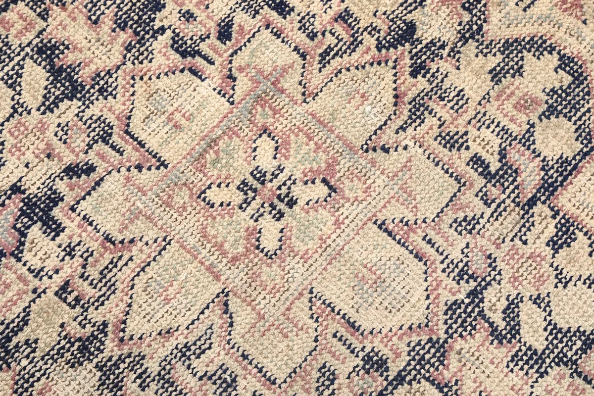 Macro view of the hand-knotted wool pile showing texture and color variation