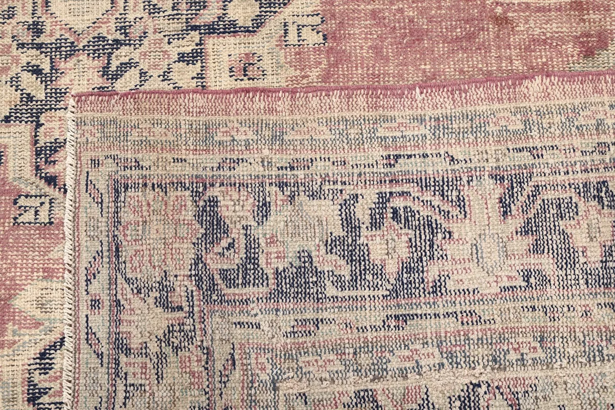 Close-up of the back of the rug, revealing the tight knotting and wool material