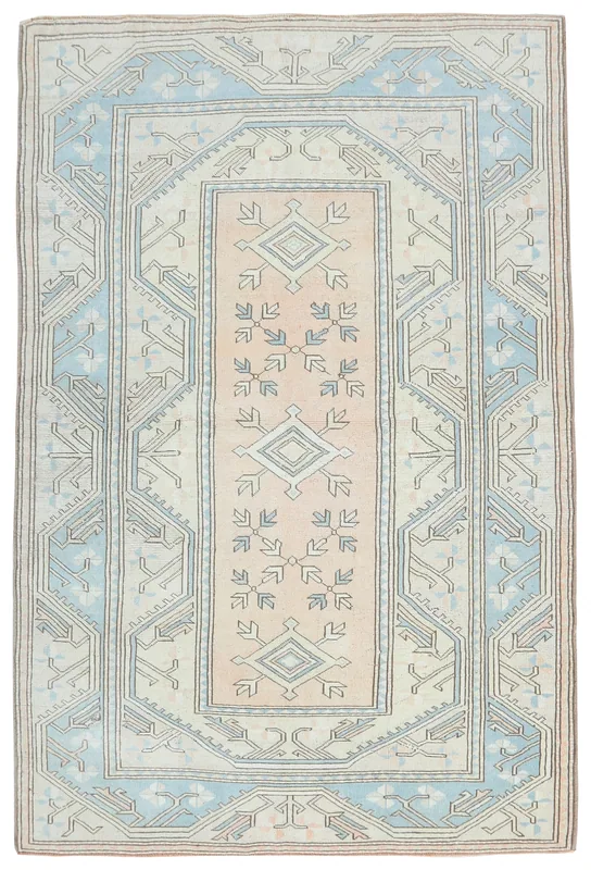 Full overhead view of the beige, blue, and rose vintage Anatolian rug