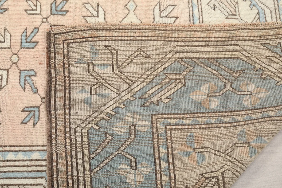 Close-up of the folded rug corner, revealing the cotton foundation
