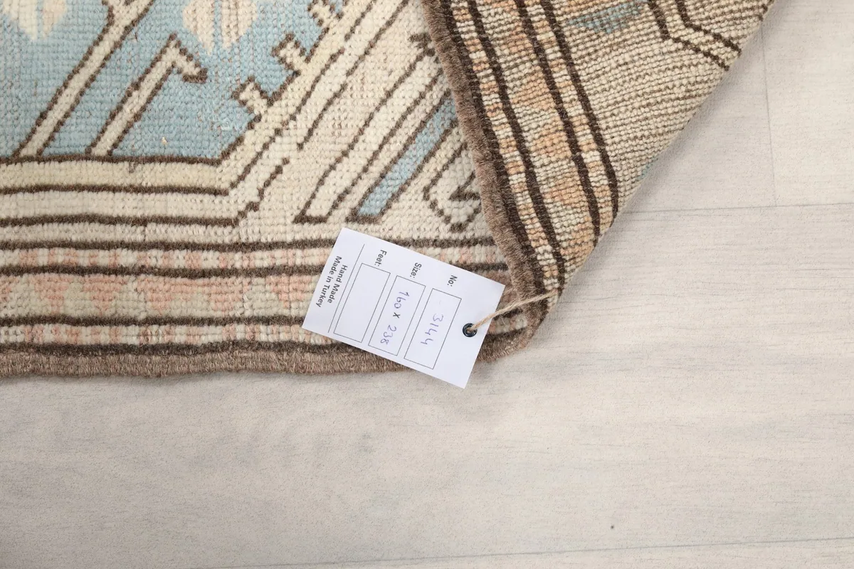 Corner of the rug with the product tag showing size and material information