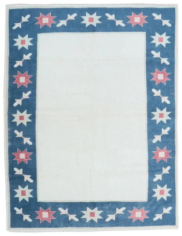 Full top view of the 5'7" x 7'5" ivory and blue vintage Anatolian rug