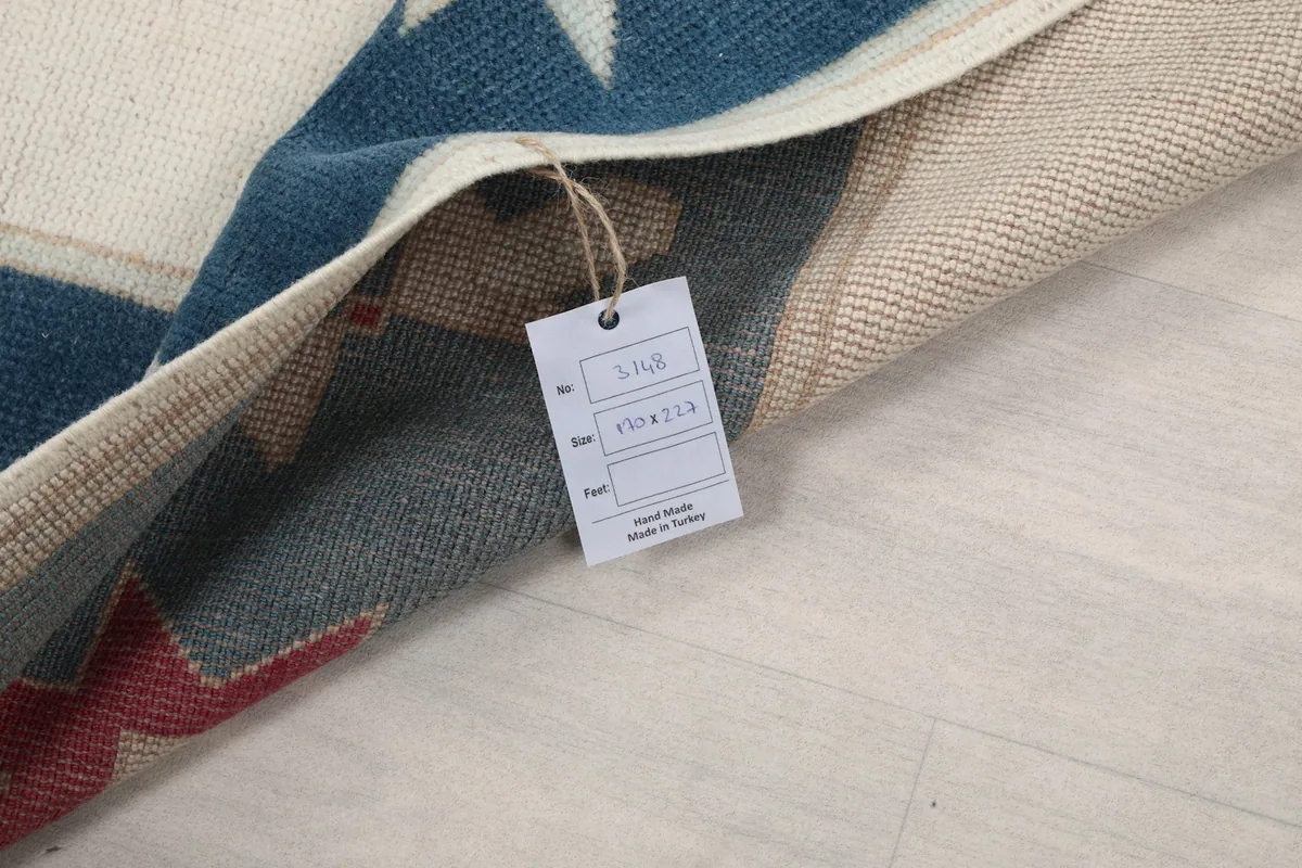 Close-up of the rug's tag, indicating hand-knotted wool and origin in Turkey