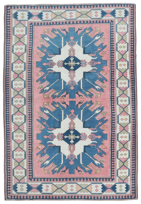 Full top view of the 6'8" x 9'9" vintage Anatolian area rug with pink field and blue geometric patterns