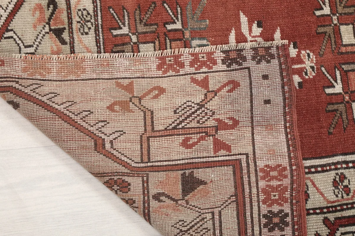 Close-up of the rug's reverse side, showing the hand-knotted wool pile on cotton foundation