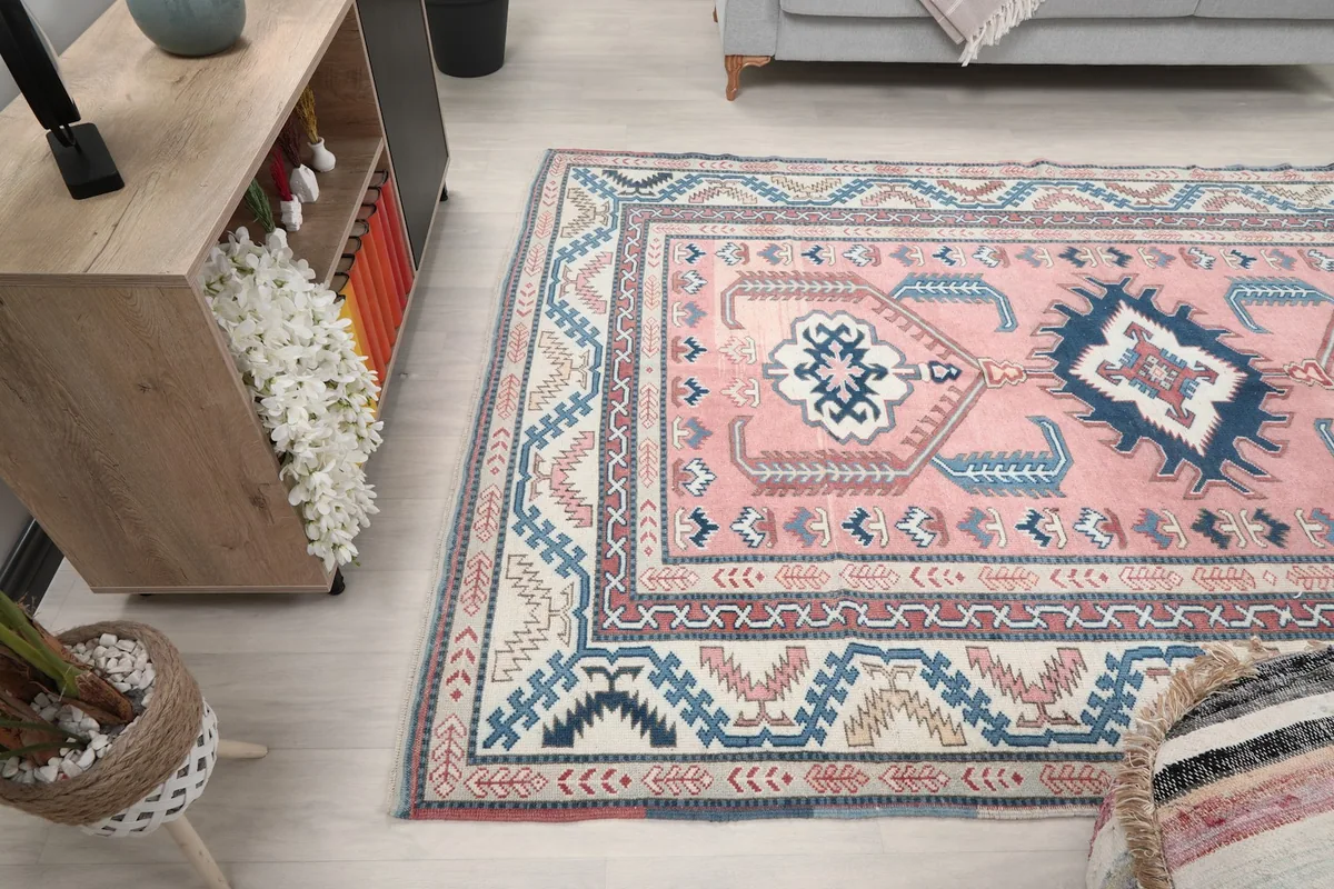 View of the pink and navy rug in a room from a different angle, showing its integration with decor.