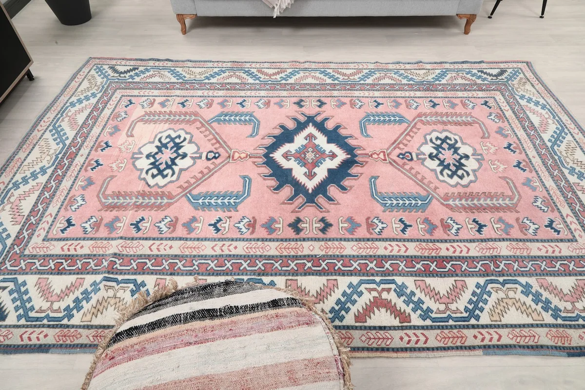 Full room shot of the large pink area rug, emphasizing its size and presence in the space.