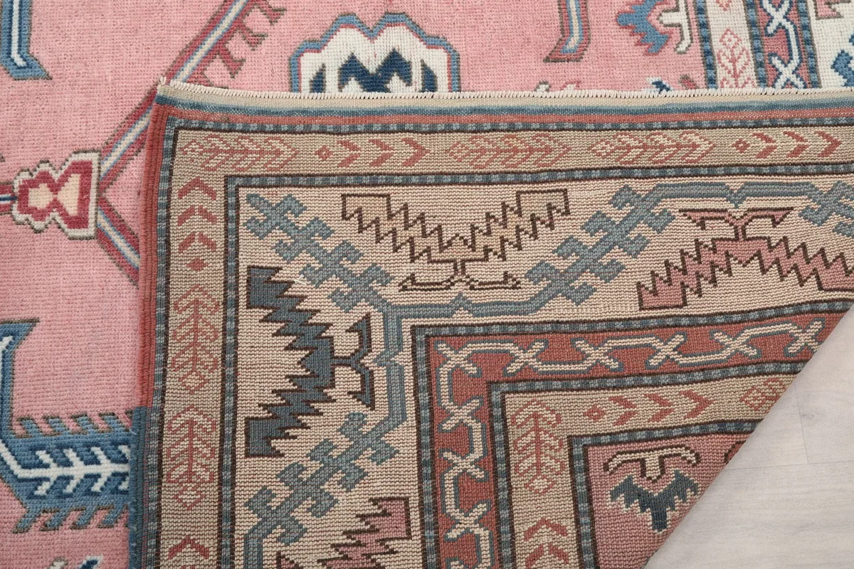 Close-up of the back of the rug, revealing the tight knotting and craftsmanship of the vintage piece.