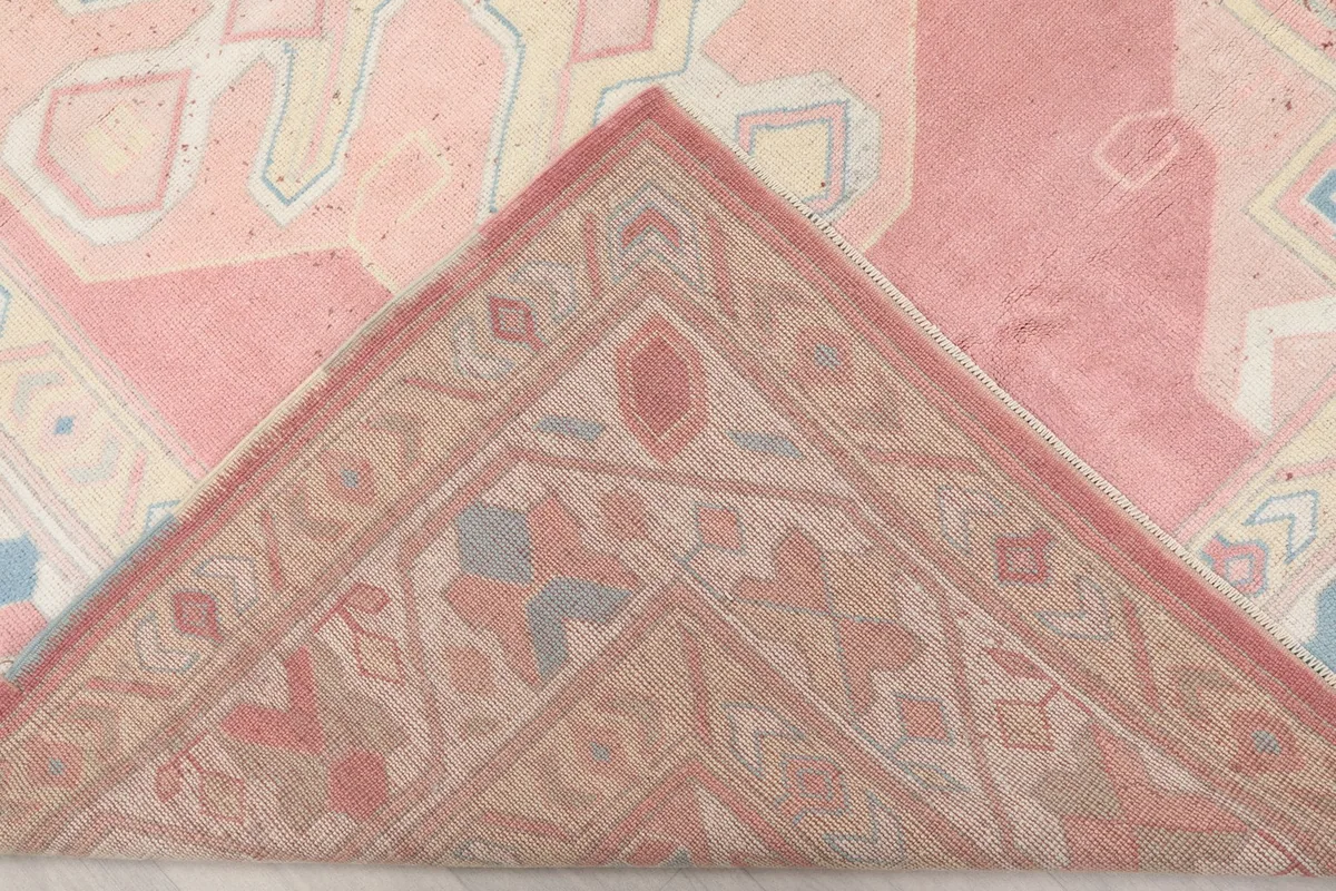 Folded corner of the rug revealing the backside of the hand-knotted wool pile