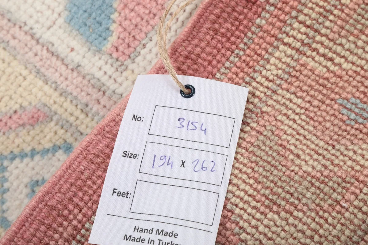 Product tag on the rug, indicating its size and handmade origin from Turkey