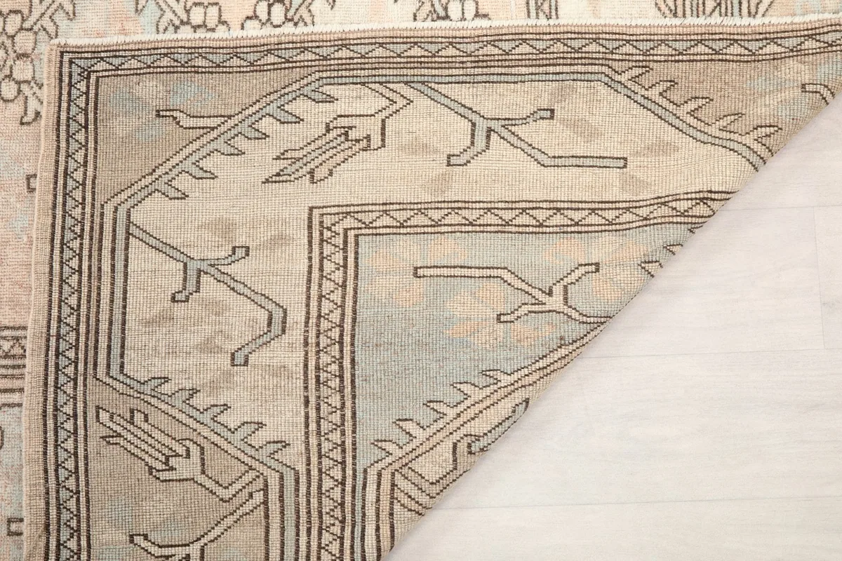 Close-up of the rug's reverse side, showing the tightly woven cotton foundation and knotting