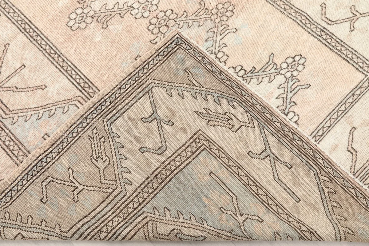 Folded corner of the rug, revealing the back of the hand-knotted cotton foundation