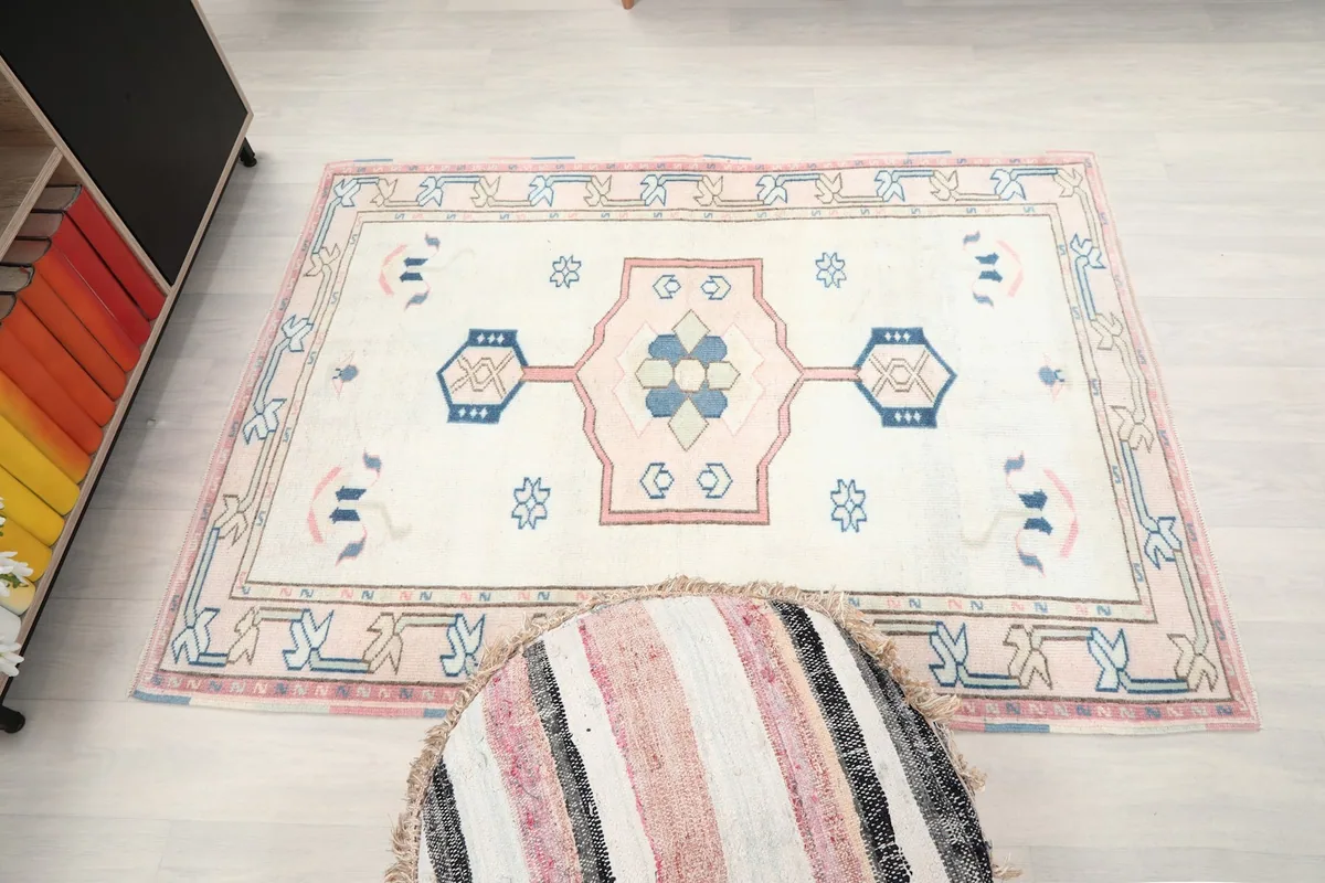 Overhead view of the ivory rug in a room, showing its full dimensions and design