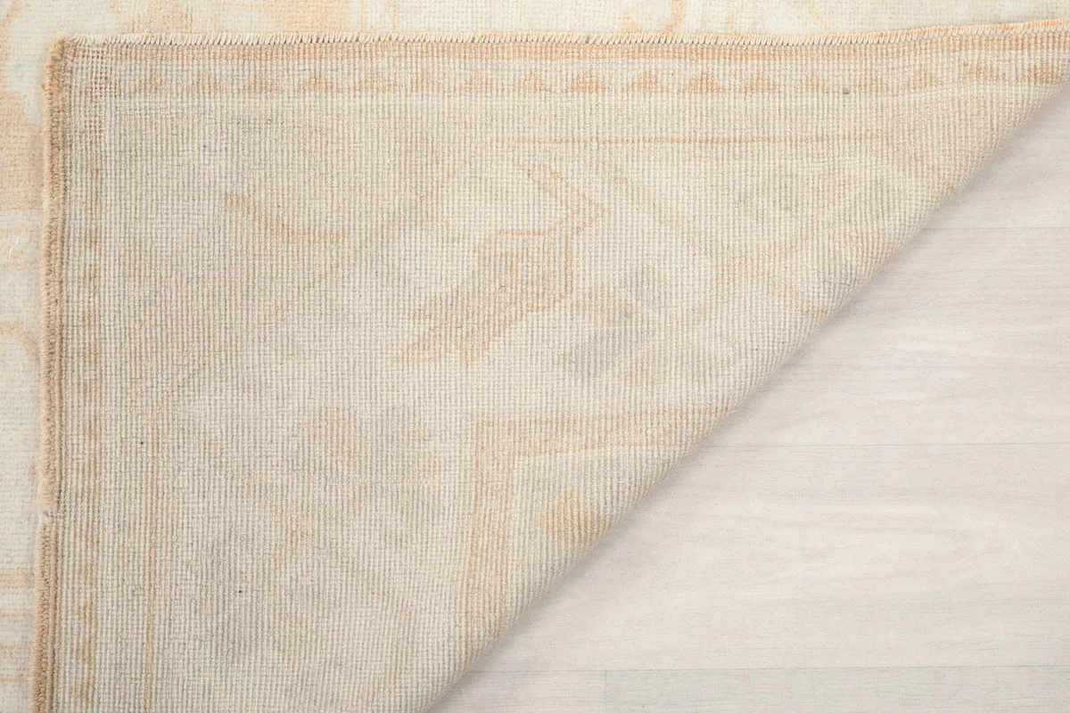 Close-up of the rug's back, revealing the tight knotting and wool pile texture.