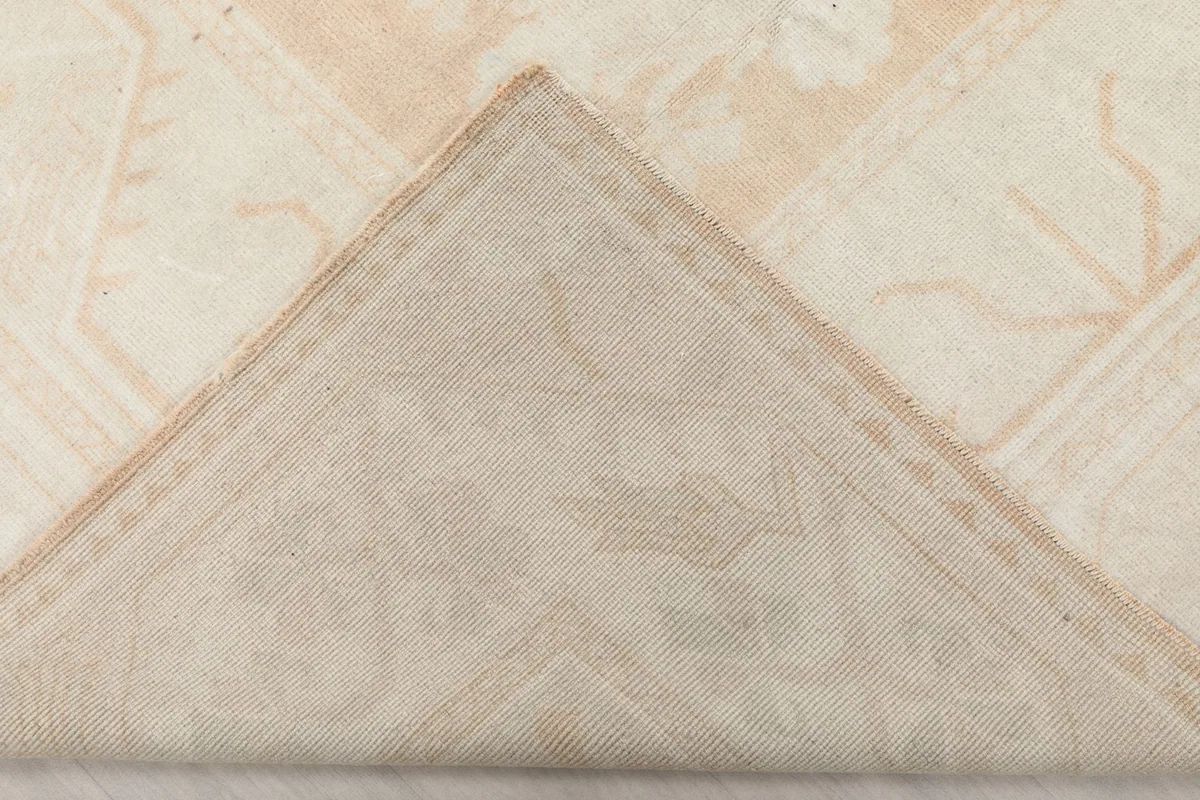 Underside view of the rug, showing the cotton foundation and hand-knotted construction.
