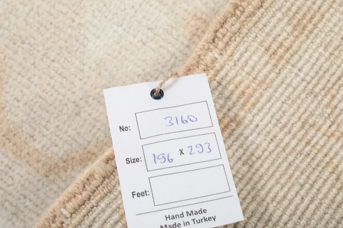 Tag displaying the rug's dimensions in centimeters and confirming it is hand made in Turkey.