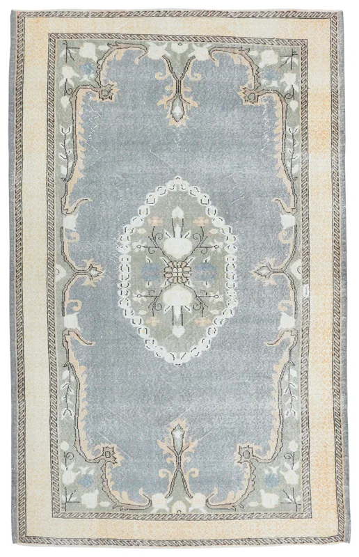Full top view of the vintage gray Anatolian wool rug with beige border and floral medallion