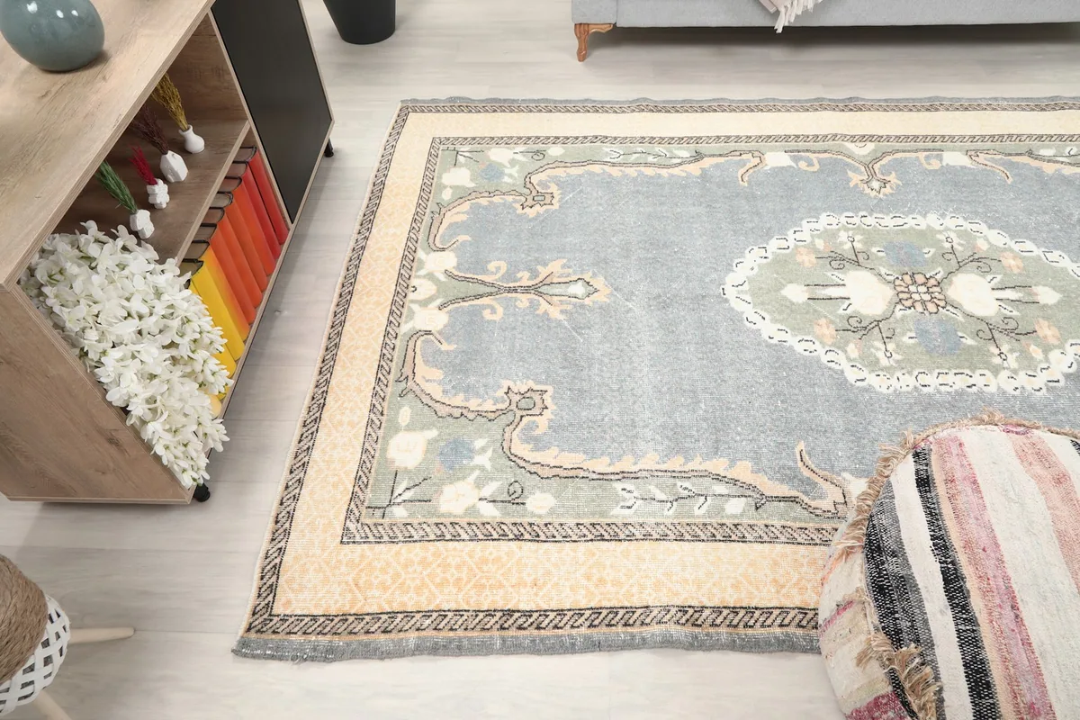 Gray Anatolian rug in a room, viewed from above, highlighting its large size