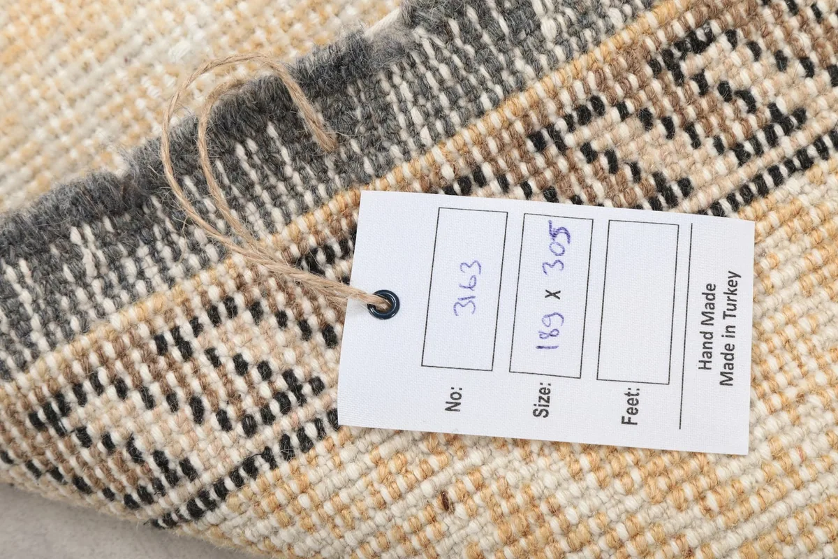 Product tag on the back of the rug displaying its dimensions and origin