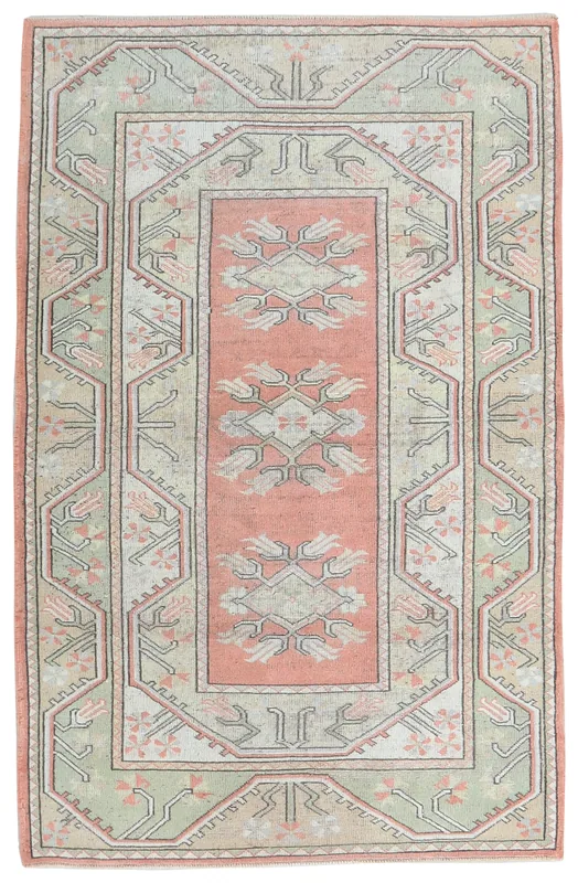 Full overhead view of the vintage Anatolian rug with rose and green geometric patterns