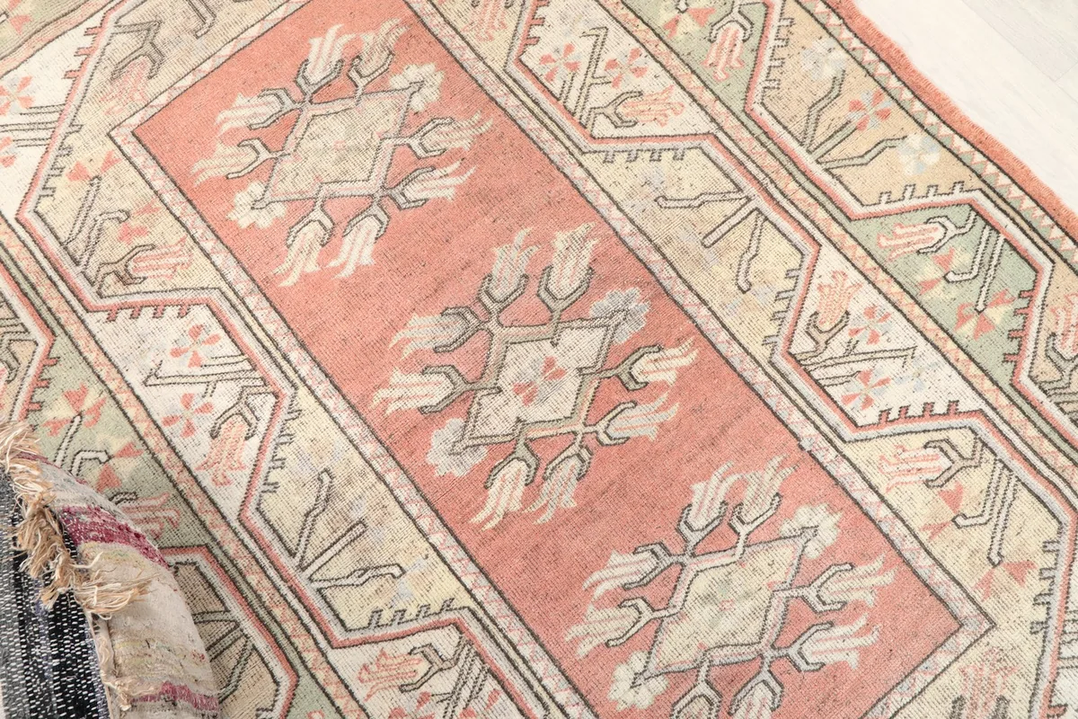 Diagonal view highlighting the central rose motifs and surrounding geometric designs