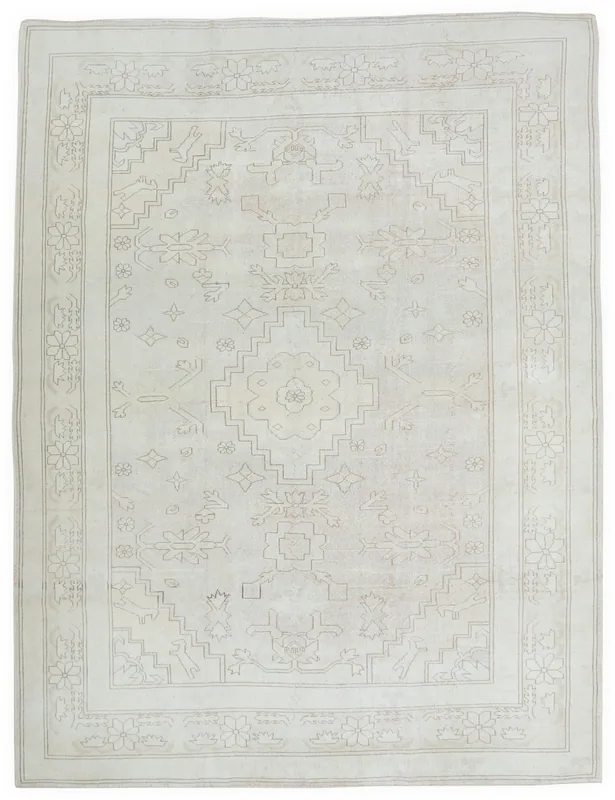 Full overhead view of the 7x9 ivory vintage Anatolian rug with geometric and floral motifs.