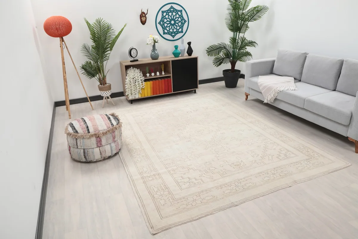 Angle view of the ivory area rug in a room, highlighting its neutral palette and subtle design.