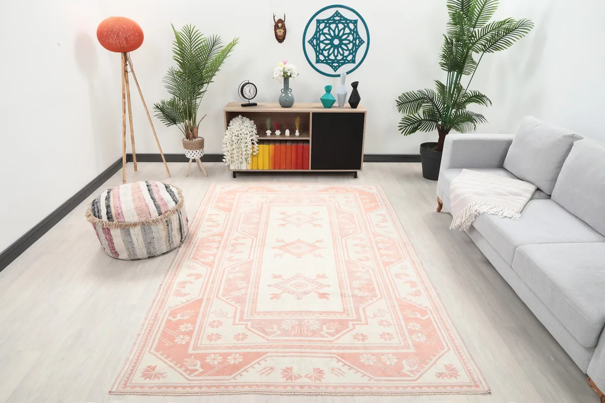 Vintage Anatolian rug in an interior room setting with a sofa and decor