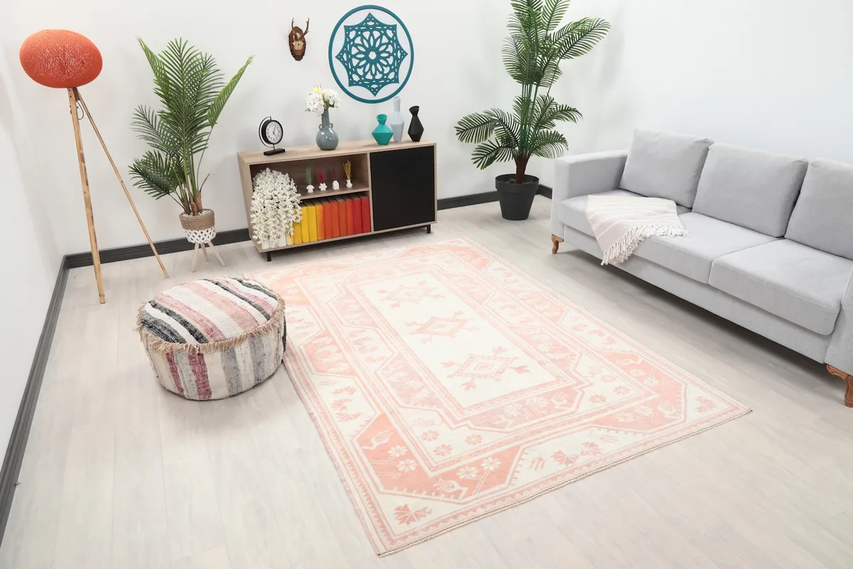 Angle view of the ivory and rose rug in a modern living space